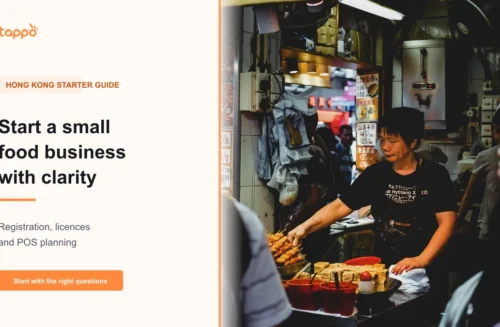 Hong Kong small food-business owner checking a menu and opening notes at a takeaway counter