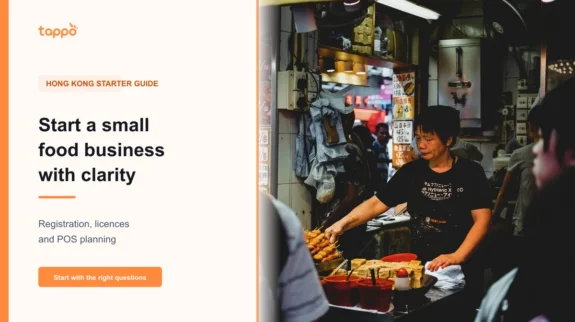 How to Start a Small Food Business in Hong Kong: Registration, Food Licences and POS Planning Hong Kong small food-business owner checking a menu and opening notes at a takeaway counter