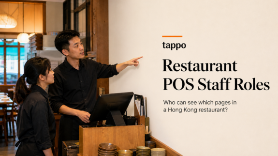 Hong Kong restaurant manager and staff member reviewing a page visibility list beside a POS counter